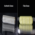 One authentic xanax bar next to one fake xanax bar
